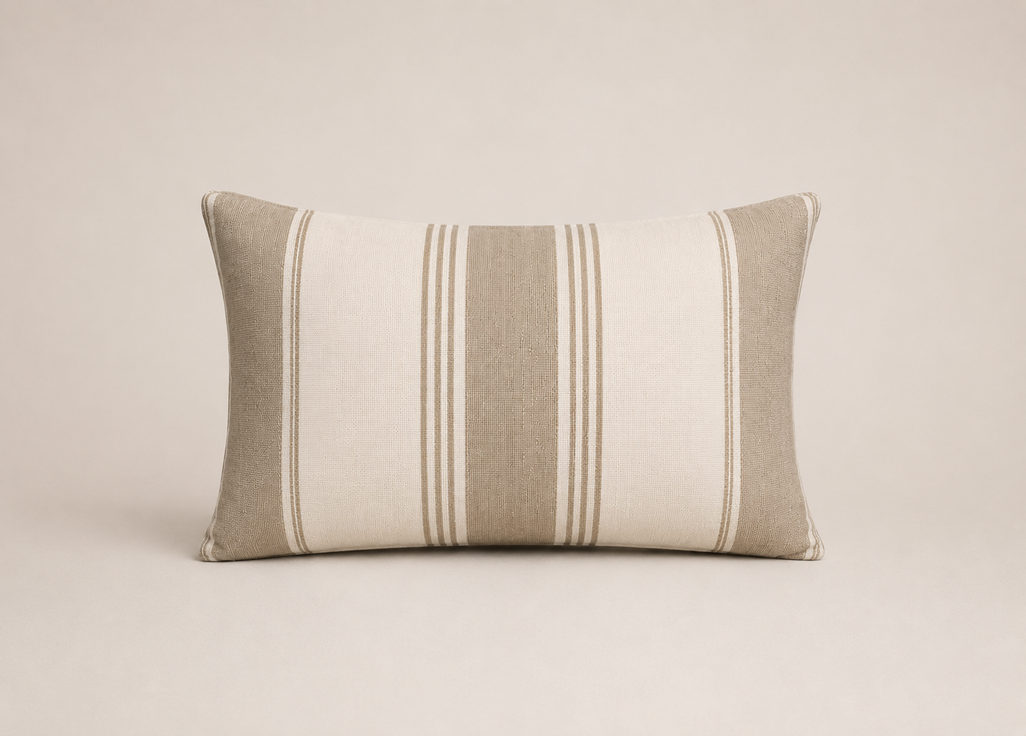 Striped pillow with beige and brown tones on a beige background