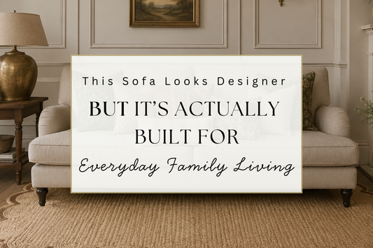 Elegant neutral sofa styled in a Georgian inspired living room with cottagecore patterned cushions, scalloped natural rug, antique brass lamp and timeless traditional interior details designed for family living.
