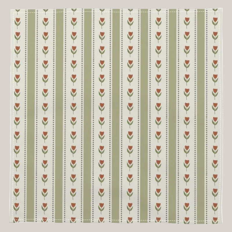 Patterned napkin with red flowers and green stripes on a white background