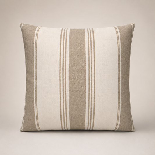 Striped pillow with beige and white pattern on a neutral background