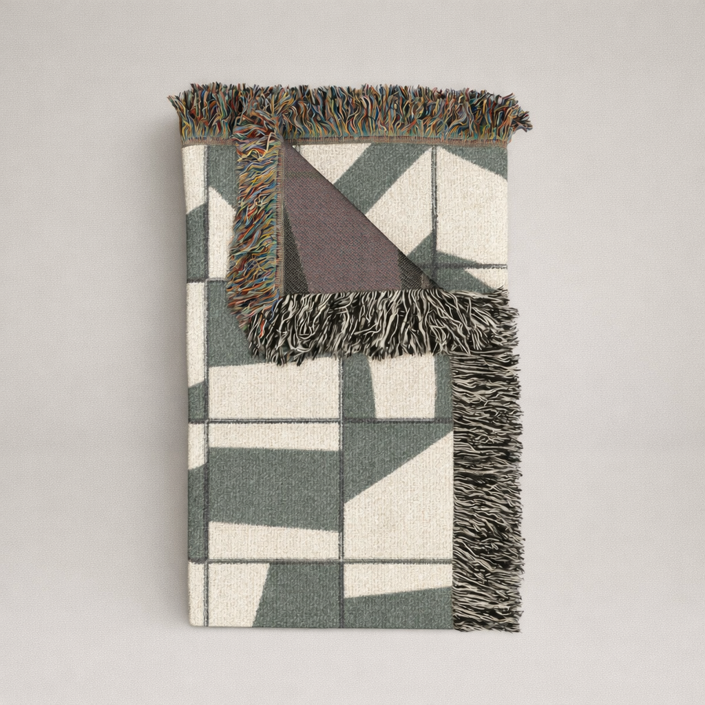 Geometric patterned rug with fringe on a plain background